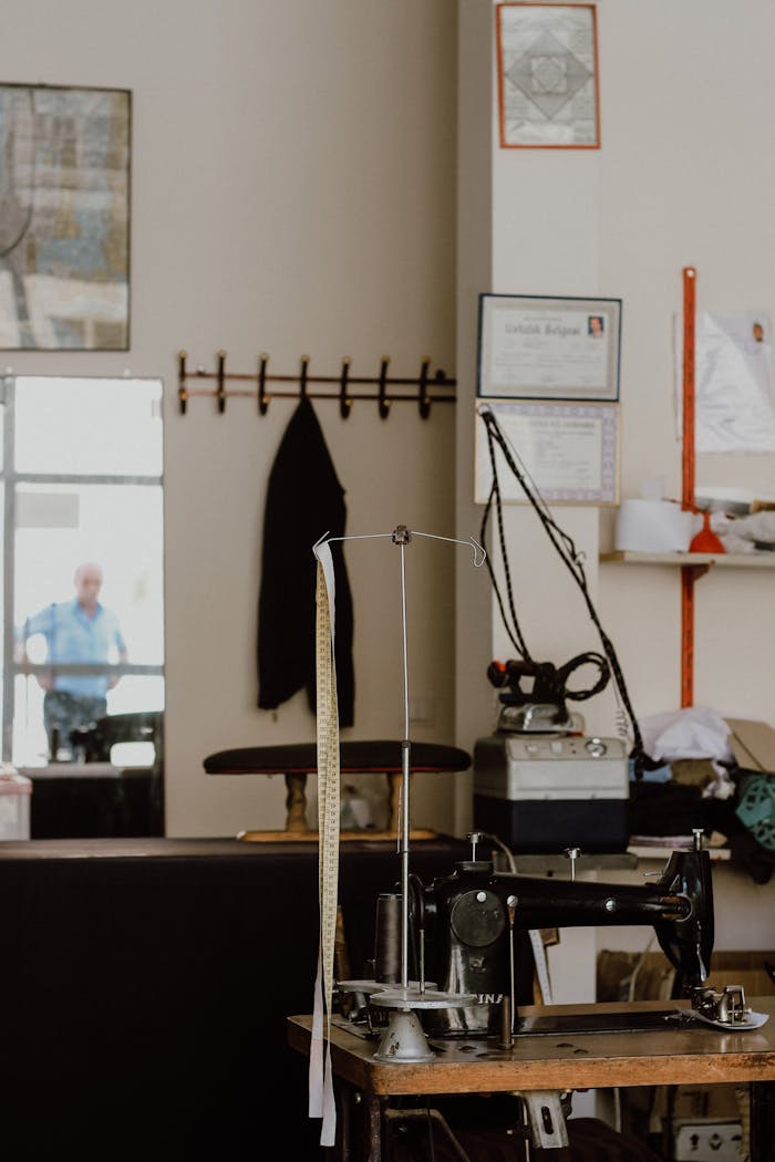 why-choose-us A vintage sewing machine in a cozy tailor shop setting, evoking a sense of nostalgia and craftsmanship.